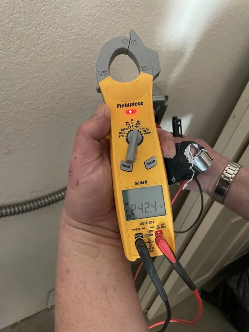 Voltage testing with clamp meter during Whole House Surge Protector in Stonecrest